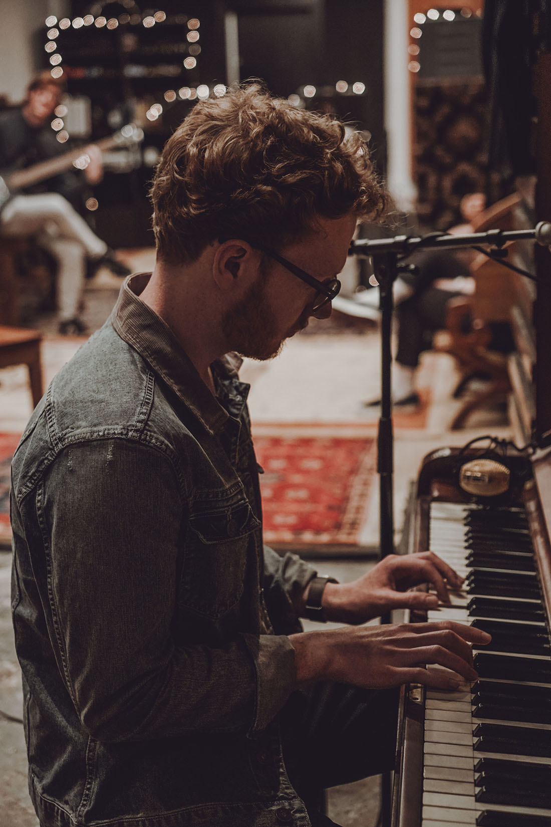 Alexander Esp playing piano in a denim jacket at Bookhouse Studios